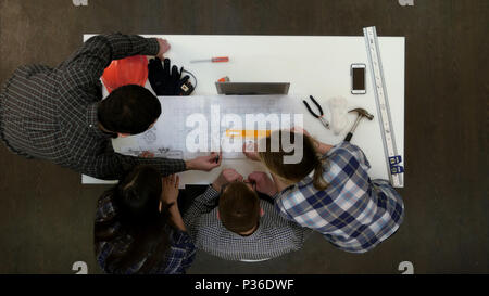 Young architects checking drawing measurements with divider Stock Photo
