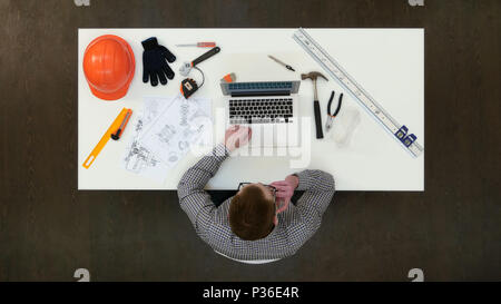 Young architect having important phone call about drawings Stock Photo