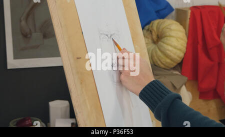 Young man learning to draw classical portrait in studio Stock Photo