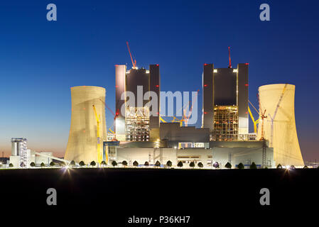 Construction site of a new brown coal power plant at night. Stock Photo