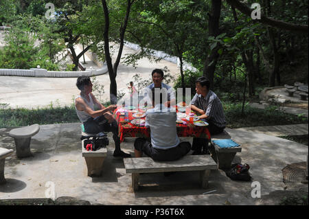 Pjoengjang, North Korea, men at a picnic in Moranbong Park Stock Photo
