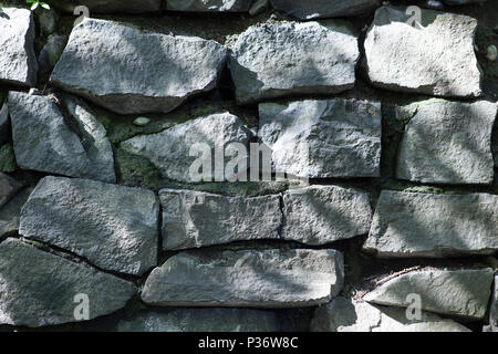 Old granite stone wall close up Stock Photo