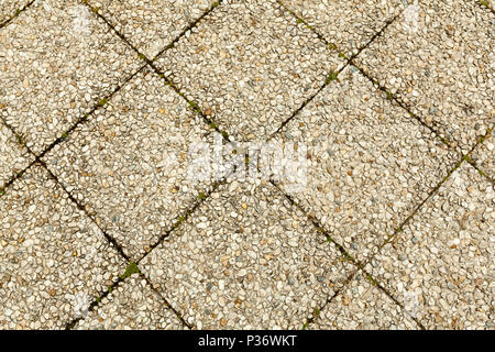 Pebble stone floor tile seamless background. Cement mixed gravel pebble stone floor texture. Wet round pebble stone rock floor in dramatic lighting Stock Photo