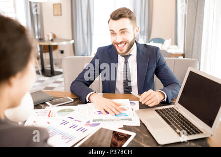 Excited business analyst working with colleague in cafe Stock Photo