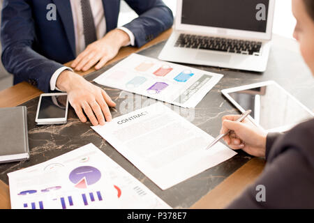 Woman signing contract with financial advisor Stock Photo