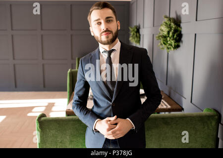 Serious successful businessman in lobby Stock Photo