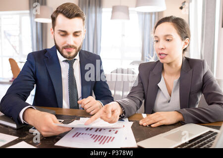 Busy managers analyzing data report Stock Photo