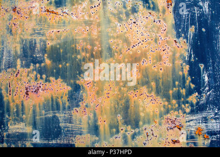 Rusty, run down, multicolor metal door in closeup Stock Photo