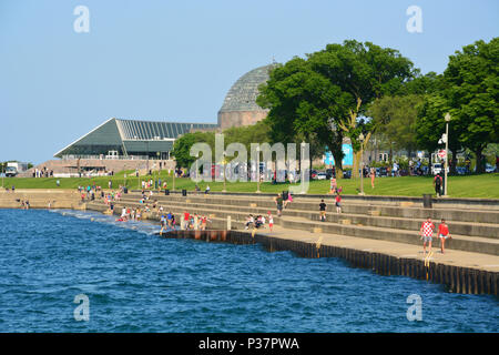 The Lake Michigan break wall along Solidarity Drive on Chicago's Museum Campus provides access to the water and a break from the heat in summer. Stock Photo