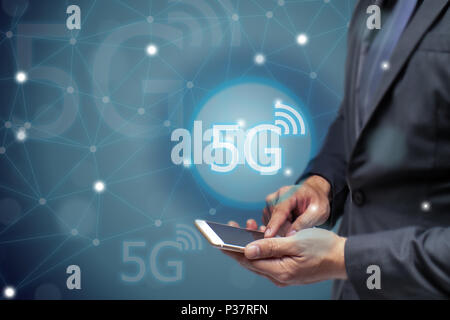 business man using mobile phone with 5g network wireless technology to connect every communication  ,iot internet of things Stock Photo