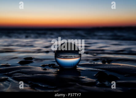 Sunset through a lens ball Stock Photo