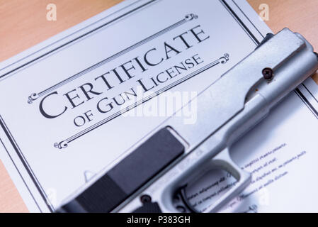 Hangun laying on a Gun / Firearms License Certificate Stock Photo