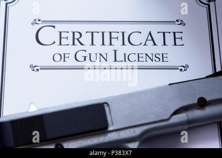 Hangun laying on a Gun / Firearms License Certificate Stock Photo