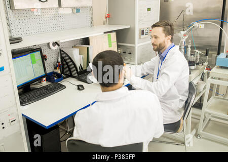 Lab Technicians Wrapped up in Work Stock Photo