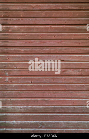 Full frame background of an old and faded wood board wall painted in red Stock Photo