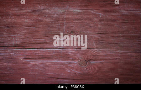 Close-up of an old and faded wood board wall painted in red with vignette Stock Photo