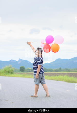 Fat boy with colorful balloon on nature background,Happy and recreation concept Stock Photo