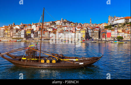 Port wine boats at the waterfront with the old town on the Douro River in Ribeira in the city centre of Porto in Porugal, Europe. Portugal, Porto Stock Photo