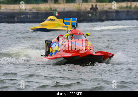 London, UK. 17th June, 2018. Erik Edin (SWE, Team Sweden) on a parade lap shortly before the start of the UIM F1H2O London Grand Prix, part of the UIM F1H2O World Championship event at Royal Victoria Dock, London, UK.  The car in the background is Francesco Cantando (ITA, Blaze Performance).  The UIM F1H2O World Championship is a series of international powerboat racing events, featuring single-seater, enclosed cockpit, catamarans which race around an inshore circuit of around 2km at speeds of up to 136mph/220kmh. Credit: Michael Preston/Alamy Live News Stock Photo