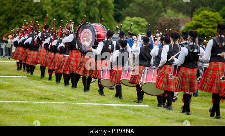 Aberdeen, Scotland - June 17, 2018: Massed pipe bands march onto the field at the Highland Games in Hazlehead Park, Aberdeen, Scotland. Credit: AC Images/Alamy Live News Stock Photo