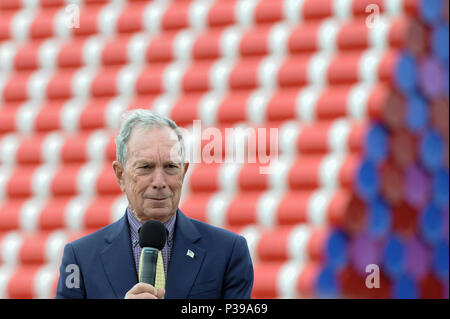 London, UK.  18 June 2018. Michael Bloomberg, Serpentine Galleries Chairman, speaks at the official unveiling of The London Mastaba by Christo and Jeanne-Claude.  Comprising 7,506 horizontally-stacked coloured barrels, in hues of red, blue, mauve and white, secured on a floating platform, it is Christo's first public outdoor work in the UK.  The geometric form takes inspiration from ancient mastabas from Mesopotamia and will be on display 18 June to 21 September 2018.  Credit: Stephen Chung / Alamy Live News Stock Photo