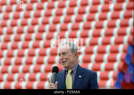 London, UK.  18 June 2018. Michael Bloomberg, Serpentine Galleries Chairman, speaks at the official unveiling of The London Mastaba by Christo and Jeanne-Claude.  Comprising 7,506 horizontally-stacked coloured barrels, in hues of red, blue, mauve and white, secured on a floating platform, it is Christo's first public outdoor work in the UK.  The geometric form takes inspiration from ancient mastabas from Mesopotamia and will be on display 18 June to 21 September 2018.  Credit: Stephen Chung / Alamy Live News Stock Photo