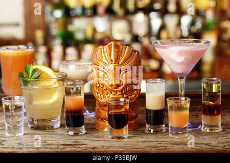 https://l450v.alamy.com/450v/p39bjw/mix-of-cocktails-in-a-nightclub-stand-in-a-row-on-a-bar-counter-on-a-blurred-background-of-alcohol-p39bjw.jpg