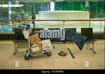 Singapore, Republic of Singapore, sleeping passenger in Changi Airport Terminal 3 Stock Photo