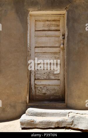 Front door in Acoma Pueblo with white peeling paint Stock Photo