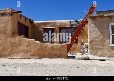 Red ladder with dangling mop in Acoma Pueblo Stock Photo