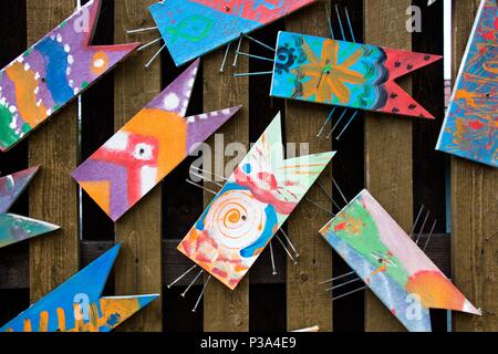 Interesting figures from the tree are painted with different colors and are attached to wooden boards. An interesting project within the framework of Stock Photo