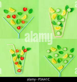 Creative pattern of strawberry and cucumber lemonade glasses made with coctail straws with falling ingredients on green background. Summer drinks. Min Stock Photo