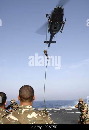 Sea (June 27, 2005) - An Italian Marine rappels from a AB-212 helicopter onto the flight deck aboard the Italian Navy fleet patrol ship ITS Granatiere (F 585), during a demonstration for Sailors and Marines from various nations. Granatiere is currently participating in exercise Barbary Thunder II, along with USS Nashville (LPD 13). Barbary Thunder II an exercise focused on developing the individual and collective maritime proficiencies of the participating nations, United States, Morocco, Tunisia, France, Italy, and Spain. Barbary Thunder is also designed to promote friendship, mutual understa Stock Photo
