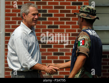 Miss. (Sept. 12, 2005) - President George W. Bush conveys his gratitude to a marine from the Federal Republic of Mexico, on their clean up efforts at 28 Street Elementary School in Biloxi, Miss. President Bush is currently visiting the Gulf Coast region to assess the damage and disaster recovery efforts from Hurricane Katrina. The Mexican Navy is assisting the U.S. Navy in providing humanitarian assistance to victims of Hurricane Katrina. The Navy's involvement in the humanitarian assistance operations are being led by the Federal Emergency Management Agency (FEMA), in conjunction with the Dep Stock Photo