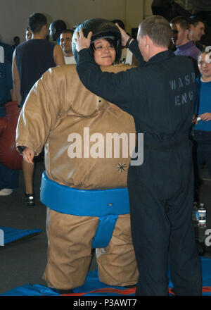 Ocean (Nov. 5, 2006) Ð Aviation Ordnanceman Airman Apprentice Karina Cortes gets suited up for a sumo-wrestling match on board the amphibious assault ship USS Wasp (LHD 1) during a steel beach picnic. Wasp is currently in transit on her way to homeport Norfolk, Va., after completing a humanitarian mission in support of Joint Task Force Lebanon. U.S. Navy Stock Photo