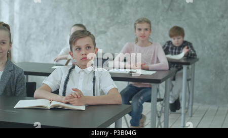Kids applauding teacher in class Stock Photo