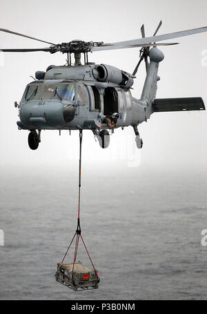 ARABIAN SEA (July 25, 2008) An MH-60S Seahawk assigned to the 'Wild Cards' of Helicopter Sea Combat Squadron (HSC) 23 participates in a vertical replenish between the Nimitz-class aircraft carrier USS Abraham Lincoln (CVN 72) and the Military Sealift Command fast combat support ship USNS Rainer (T-AOE 7). Lincoln is deployed to the U.S. 5th Fleet area of responsibility supporting Operations Iraqi and Enduring Freedom as well as maritime security operations. Stock Photo