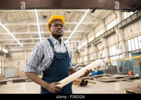 Confident African-American construction manager at workplace Stock Photo