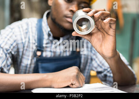 Engineer examining bushing Stock Photo
