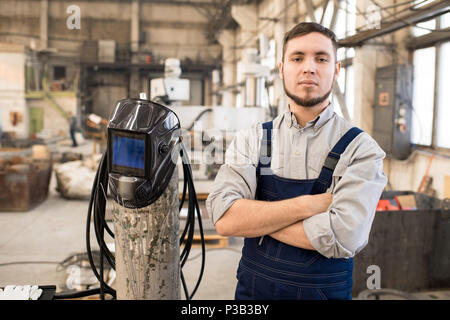 Purposeful handsome welder in factory workshop Stock Photo