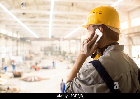 Busy construction manager calling customer Stock Photo