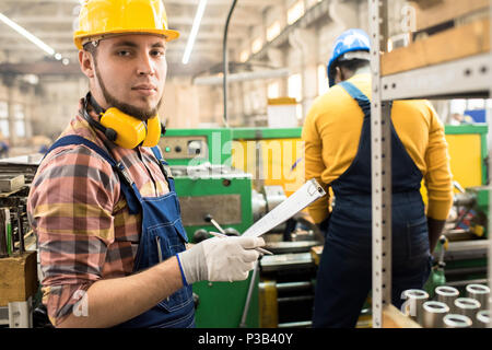 Serious factory employee responsible for quality control Stock Photo