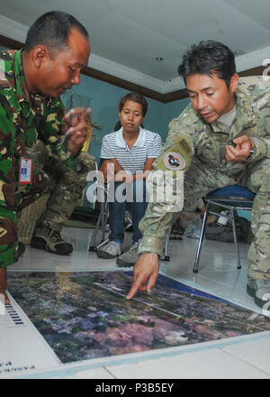 U.S. Air Force Staff Sgt. Christopher Lugo, right, assigned to the 353rd Special Operations Group, points out damaged aviation navigation aids during a meeting with Indonesian airmen at Ta Bing Air Field in Padang, Indonesia, Oct. 7, 2009. The service members are meeting to discuss the restoration of the aids to better facilitate flight operations in support of ongoing humanitarian relief efforts in Padang. The U.S. military is responding to a request for assistance by the Indonesian government after a 7.6 magnitude earthquake struck the country Sept. 30, 2009. (DoD