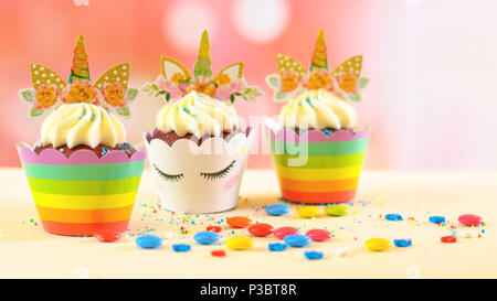 Adelaide, South Adelaide - June 15, 2018: Children's birthday party unicorn and rainbow themed cupcakes, close up against a colorful pastel background Stock Photo
