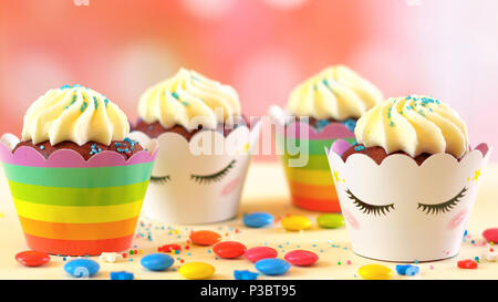 Adelaide, South Adelaide - June 15, 2018: Children's birthday party unicorn and rainbow themed cupcakes, close up against a colorful pastel background Stock Photo