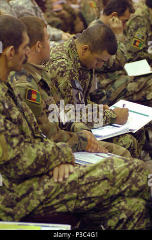 (Kabul, Afghanistan) An Afghan National Army Soldier takes notes at the sixth semi-annual Sergeant Major conference in Kabul. More than one hundred senior enlisted ANA and coalition soldiers attended the seminar held at the Afghan National Army Air Corp auditorium, to share ideas and experiences beneficial to Afghanistan’s non-commissioned officer corps. Stock Photo