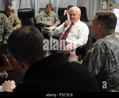 EGGERS, Afghanistan – United States Secretary of Defense Robert Gates, center, receives a briefing from U.S. Army Lt. Gen. William Caldwell IV, right, Commander of NATO Training Mission – Afghanistan during Gates’ visit to Camp Eggers Dec. 8, 2009. Camp Eggers is the headquarters for the newly established command, NATO Training Mission - Afghanistan and Combined Security Transition Command - Afghanistan. Stock Photo