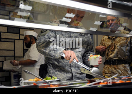 KABUL, Afghanistan – Maj. Gen. Michael Bednarek, commander First Army Division East, serves himself at the “GOAT” dining facility salad bar, at Camp Eggers, Afghanistan, prior to a strategy dinner on Dec. 10, 1009. The meeting was hosted by Lt. Gen. William B. Caldwell, IV, commander NATO Training Mission – Afghanistan, and included Lt. Gen. Thomas G. Miller, commanding general First Army, Brig. Gen. Gary S. Patton, assistant commanding general, programs, and Brig. Simon Levey, commander Combined Training Advisory Group. The generals discussed better utilization of reserve military forces in o Stock Photo