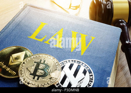 Crypto regulation. Cryptocurrency coins and book Law. Stock Photo
