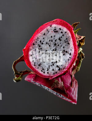 Exotic fruit Pitahaya isolated on a black glossy background Stock Photo